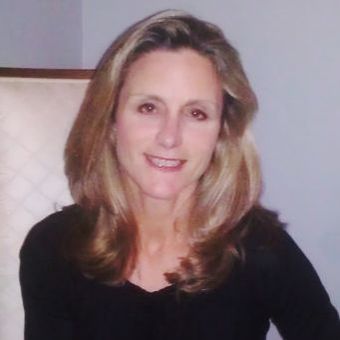 JoAnn Pileggi, smiling, in a black top